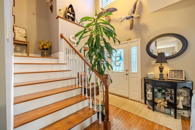 a view of entryway and hall with wooden floor