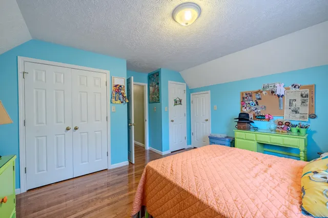 a bedroom with a bed and a mirror