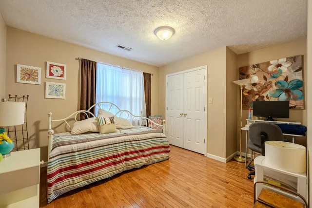 a bedroom with a bed and a chair