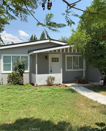 a view of house with backyard