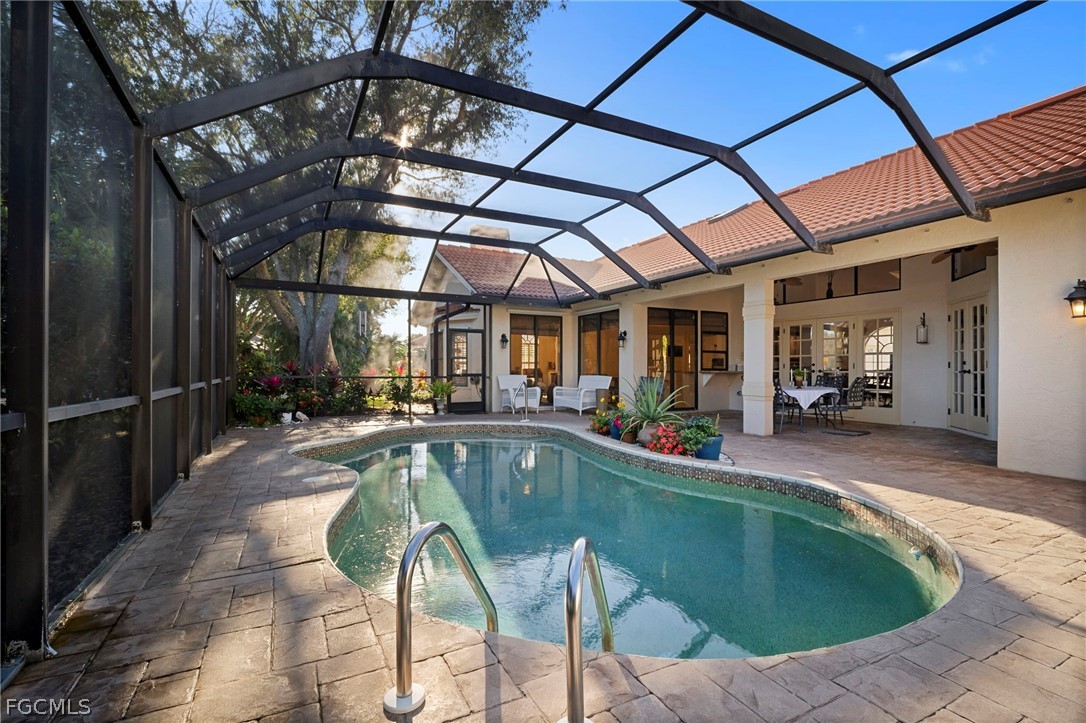 11772 Mahogany Run Fort Myers, FL 33913 - Photo 43 of 50 a view of a swimming pool with a patio and a yard