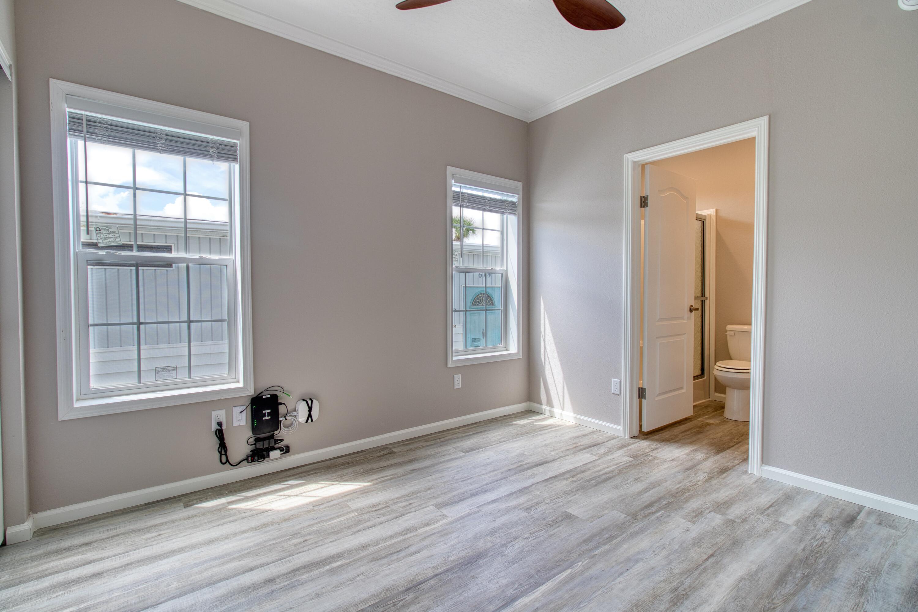 10701 South Ocean Drive, Unit 613 Jensen Beach, FL 34957 - Photo 12 of 64 an empty room with wooden floor and windows