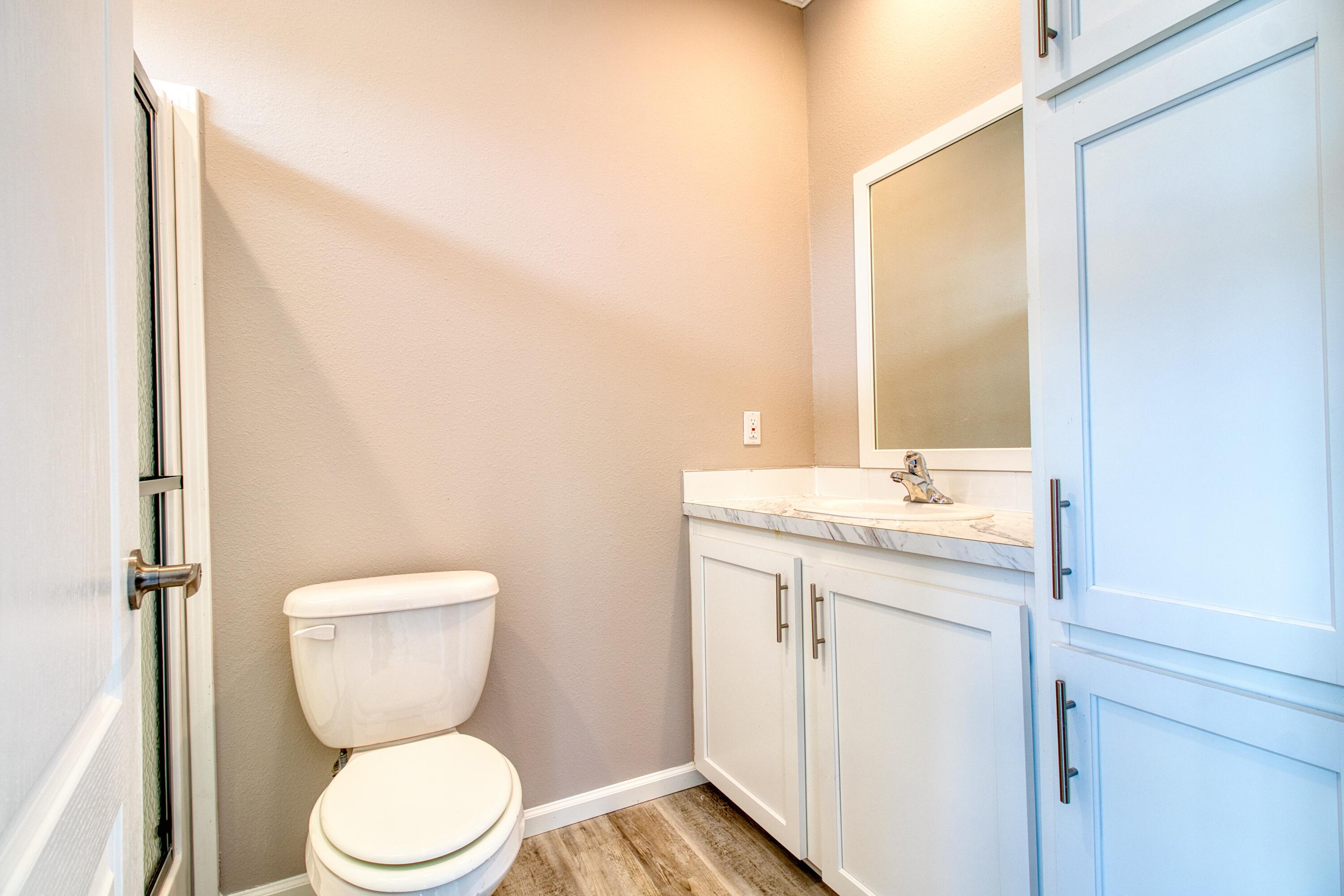 10701 South Ocean Drive, Unit 613 Jensen Beach, FL 34957 - Photo 14 of 64 a bathroom with a toilet a sink and a mirror