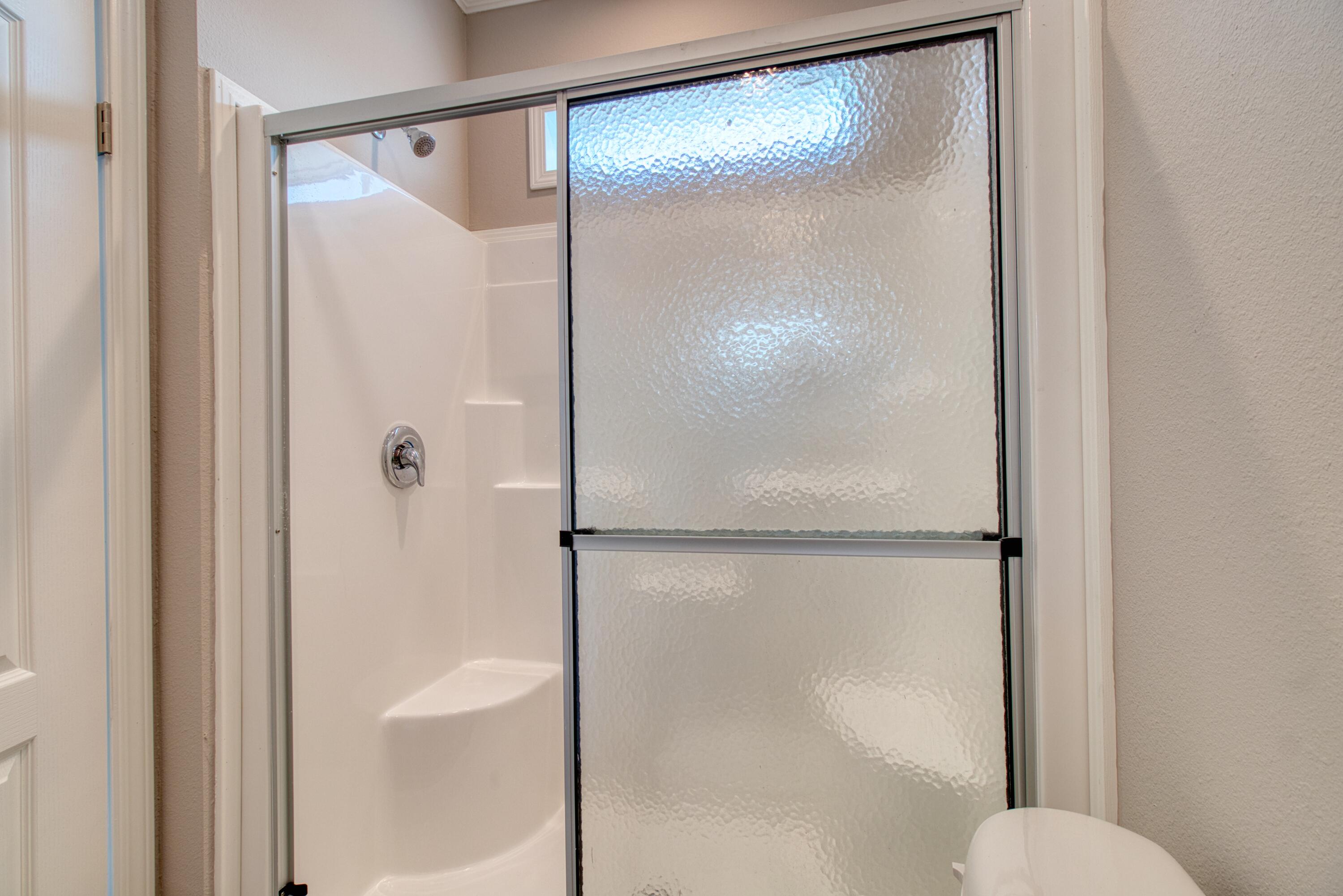 10701 South Ocean Drive, Unit 613 Jensen Beach, FL 34957 - Photo 15 of 64 a bathroom with a glass shower door