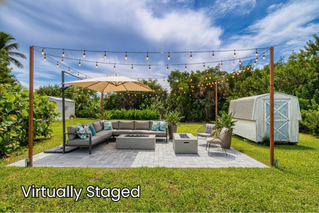 10701 South Ocean Drive, Unit 613 Jensen Beach, FL 34957 - Photo 25 of 64 a view of a couches in patio and a yard