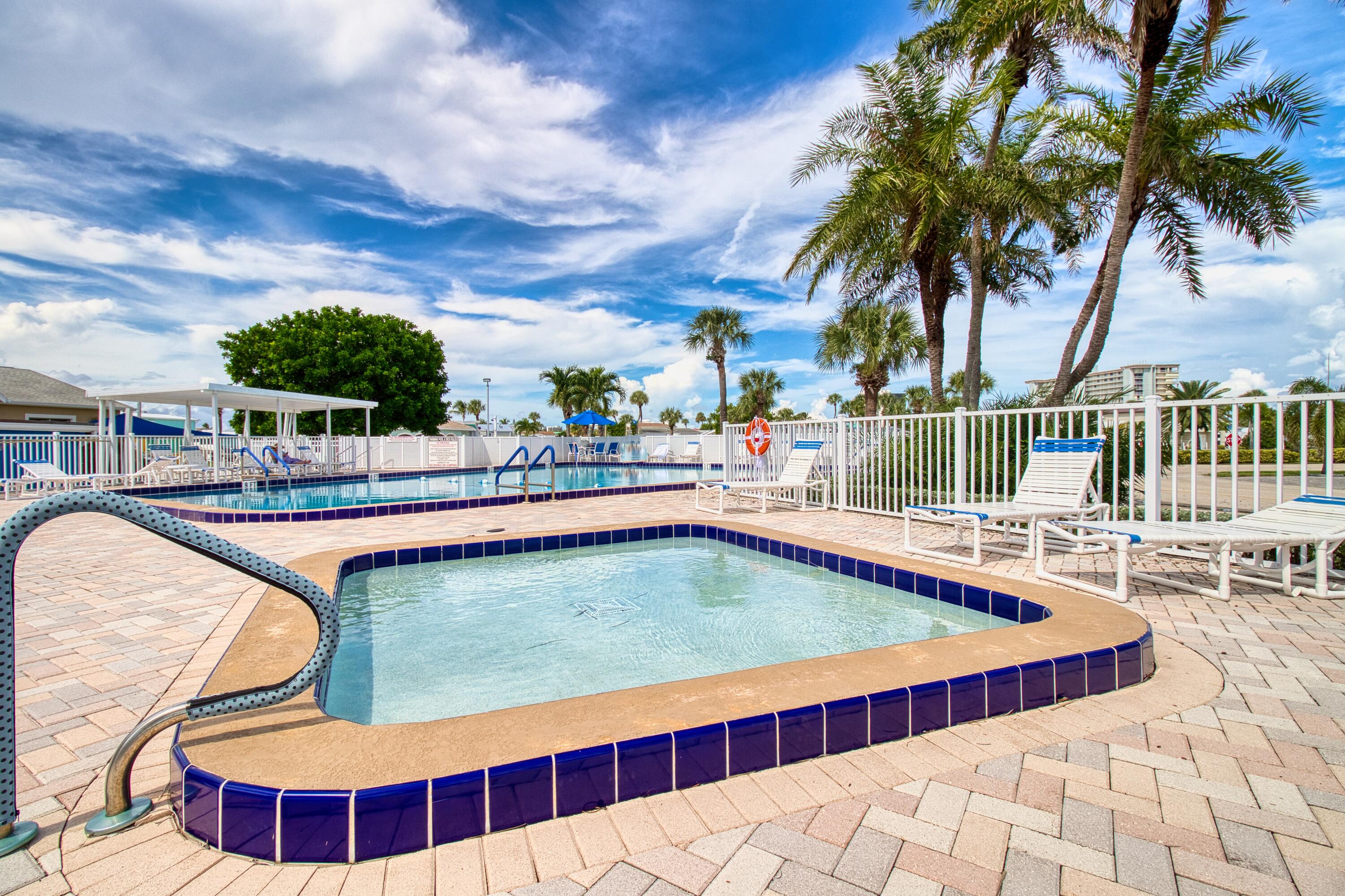 10701 South Ocean Drive, Unit 613 Jensen Beach, FL 34957 - Photo 32 of 64 a swimming pool with outdoor seating and yard