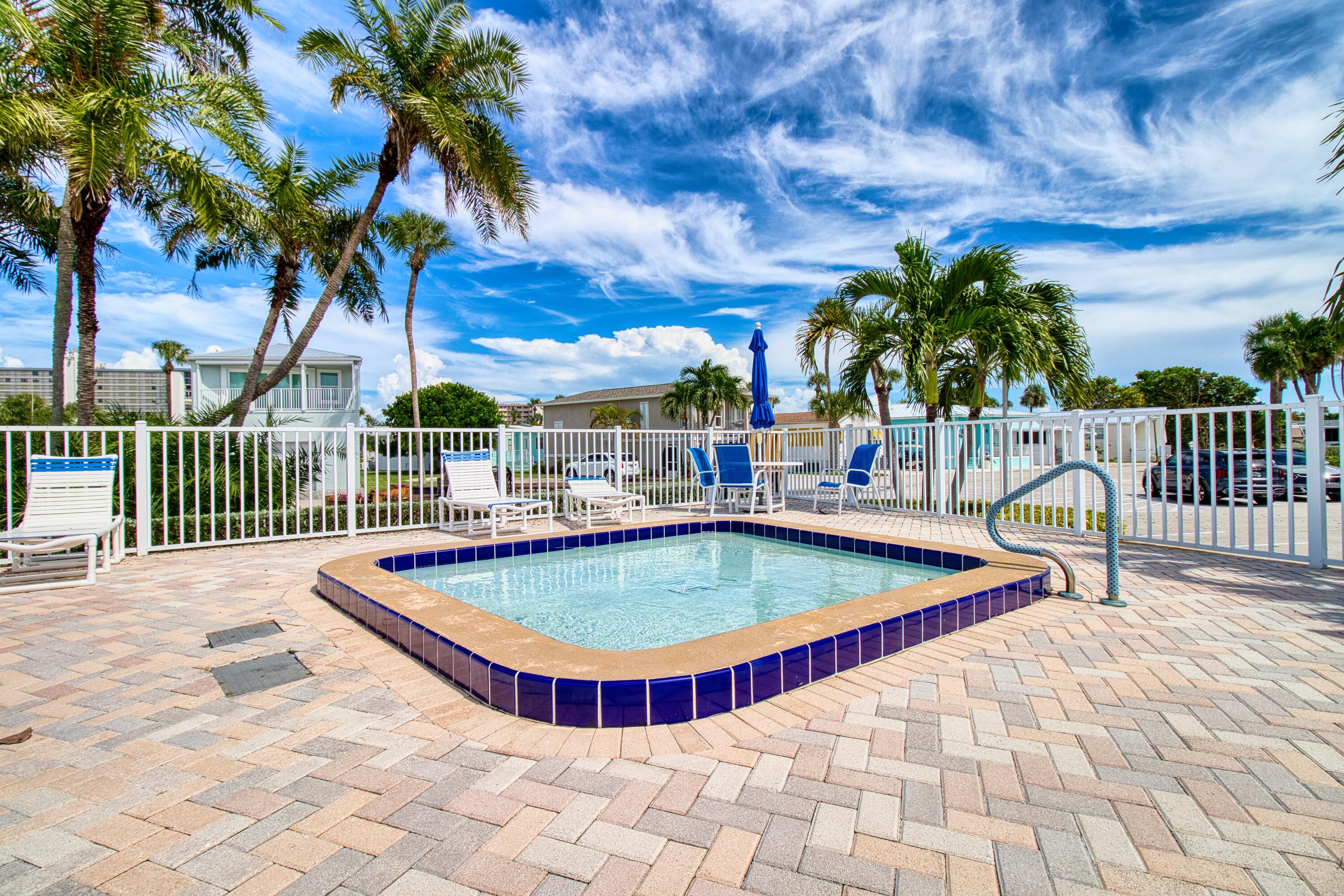 10701 South Ocean Drive, Unit 613 Jensen Beach, FL 34957 - Photo 33 of 64 a swimming pool with outdoor seating and yard