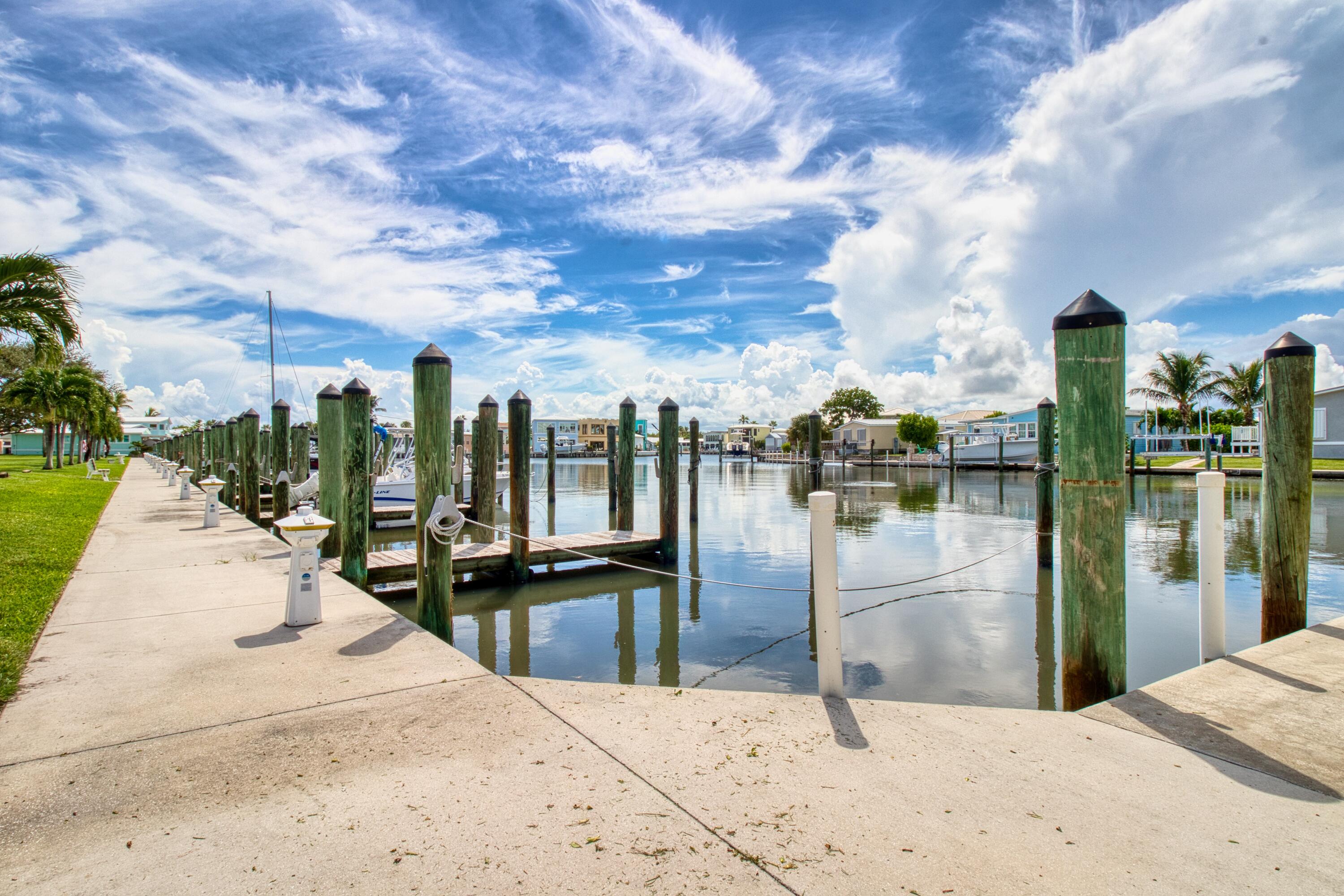 10701 South Ocean Drive, Unit 613 Jensen Beach, FL 34957 - Photo 36 of 64 a swimming pool with outdoor seating and lake view