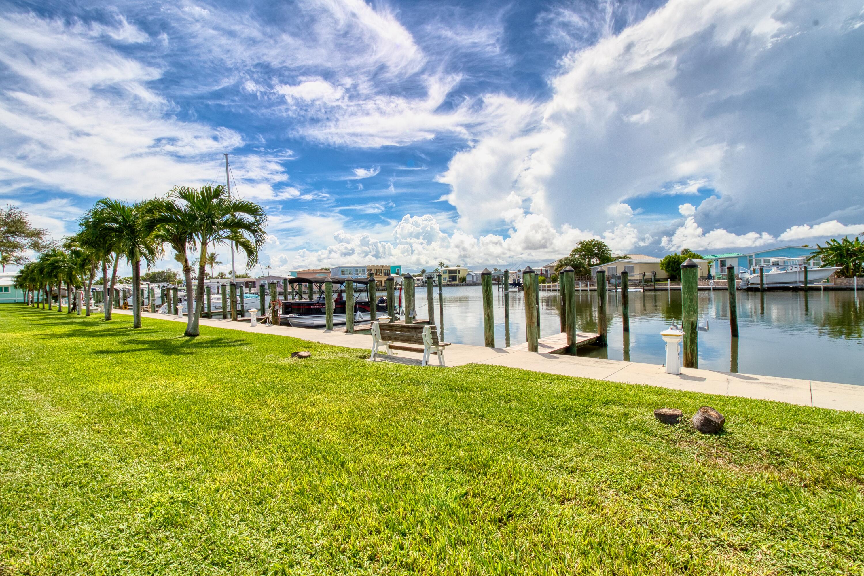 10701 South Ocean Drive, Unit 613 Jensen Beach, FL 34957 - Photo 37 of 64 a view of a lake with a big yard and large trees