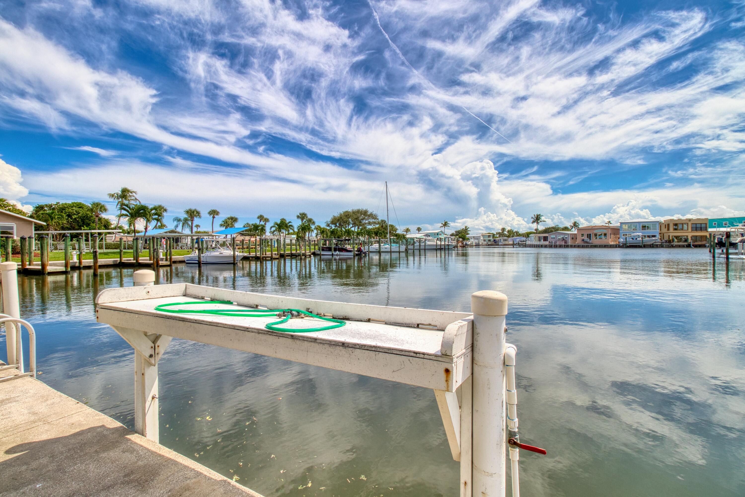 10701 South Ocean Drive, Unit 613 Jensen Beach, FL 34957 - Photo 38 of 64 a view of a lake with houses in the back