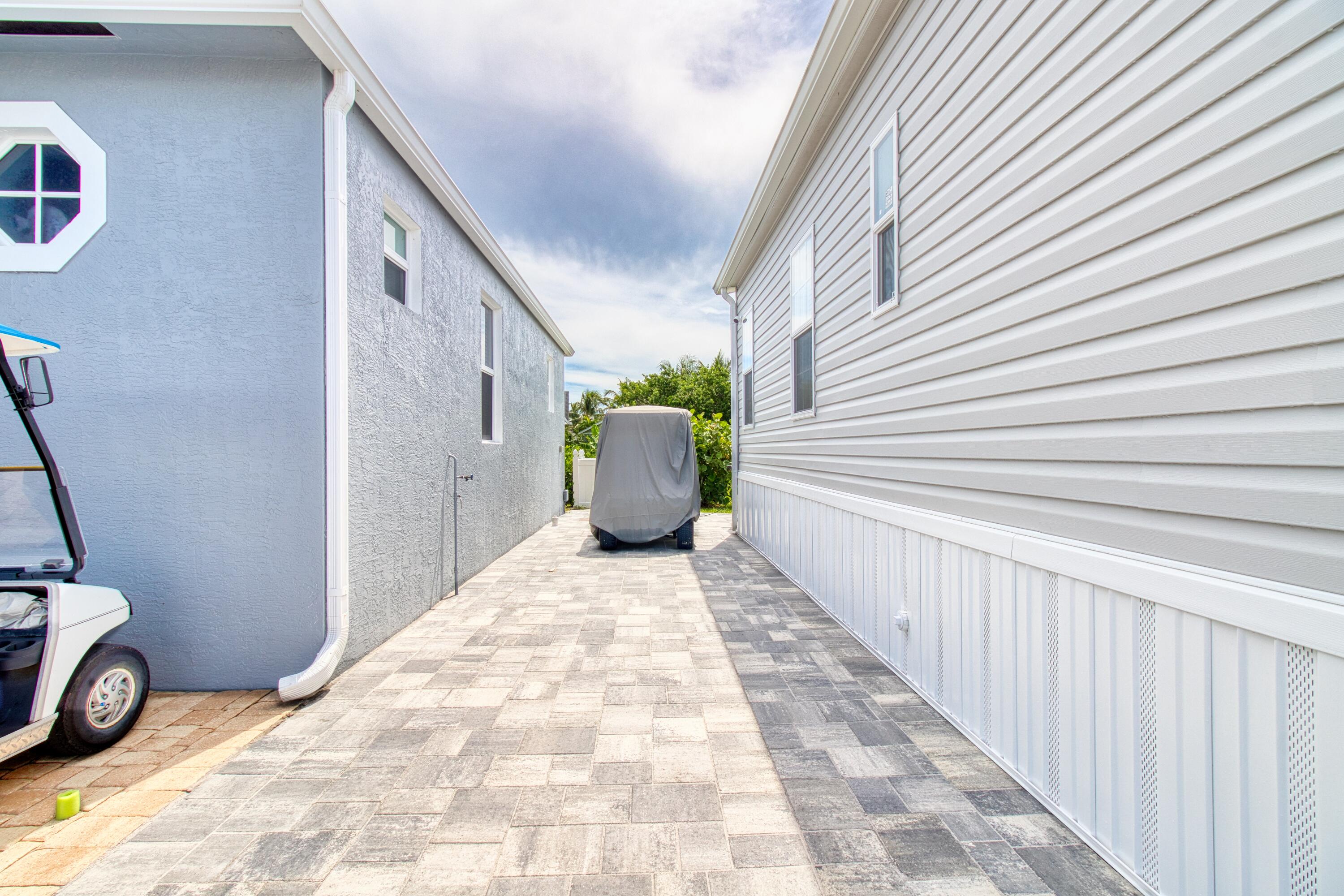 10701 South Ocean Drive, Unit 613 Jensen Beach, FL 34957 - Photo 4 of 64 a view of a backyard with chair and white walls