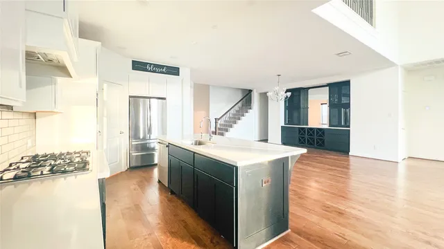 a kitchen with a sink and a stove top oven