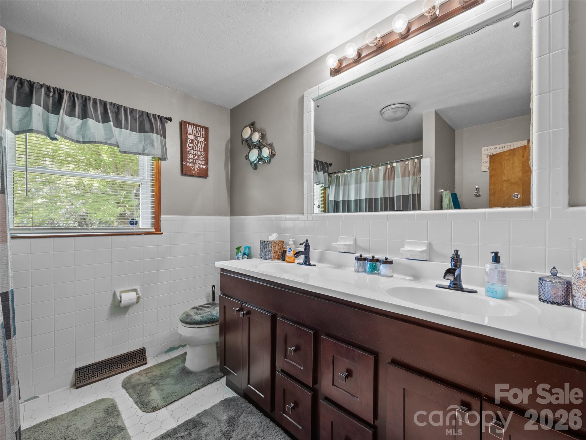 50 Baldwin Road Arden, NC 28704 - Photo 21 of 24 a bathroom with a double vanity sink toilet and a mirror