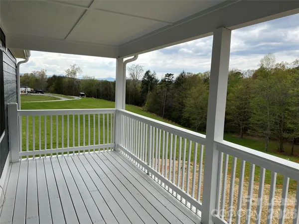 a kitchen with a sink white cabinets and white appliances