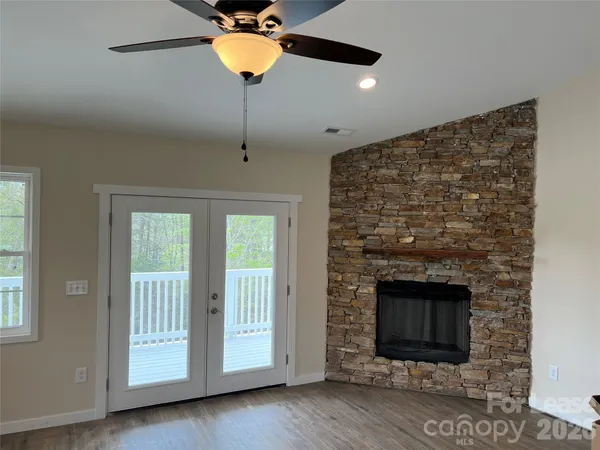 a kitchen with kitchen island granite countertop a sink window and stainless steel appliances