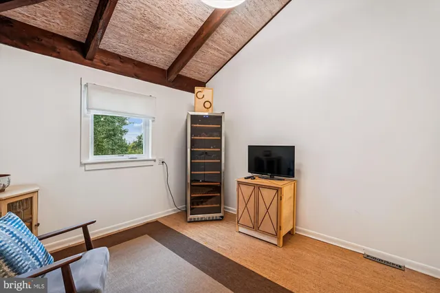a view of a livingroom with lounge chair and a couch
