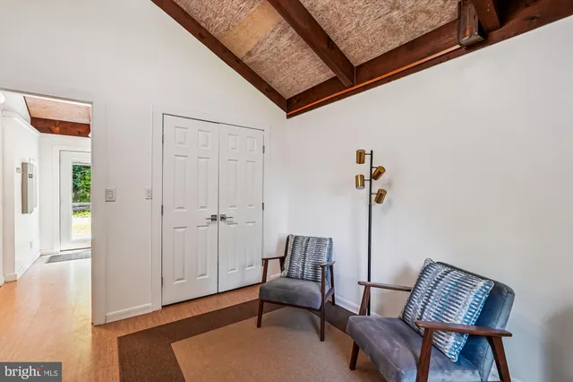 a view of room with wooden floor and flat screen tv