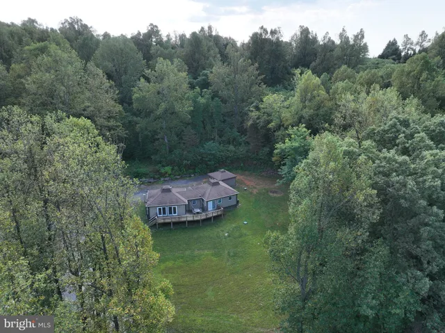 an aerial view of a house with a yard
