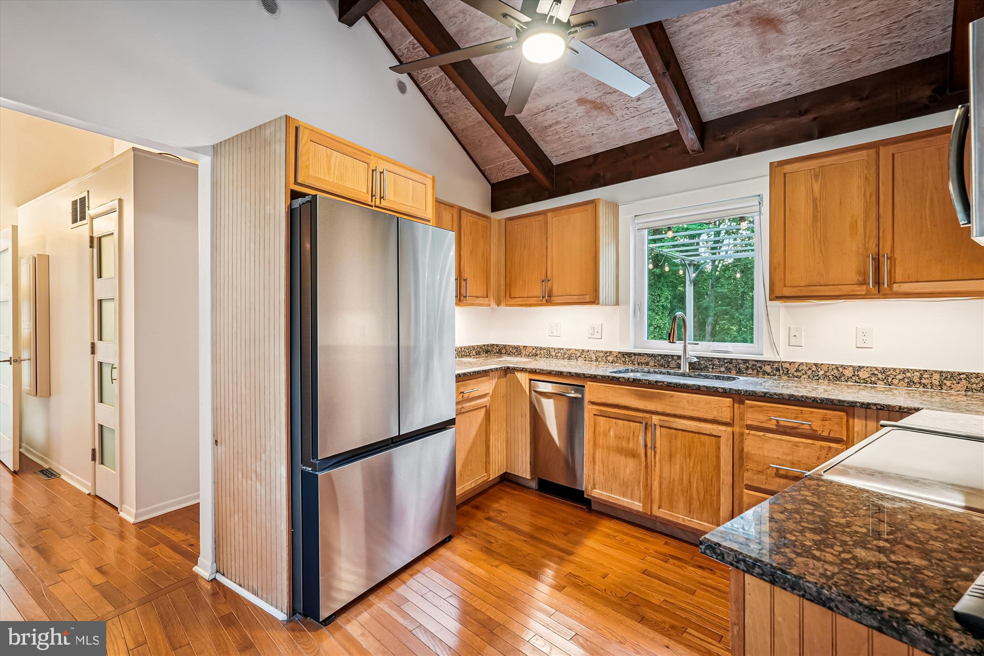 21826 Blue Ridge Mountain Road Paris, VA 20130 - Photo 21 of 60 a kitchen with stainless steel appliances granite countertop a refrigerator a sink dishwasher a stove and white countertops with wooden floor