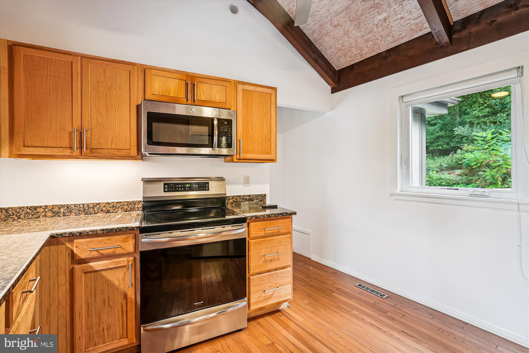 21826 Blue Ridge Mountain Road Paris, VA 20130 - Photo 23 of 60 a kitchen with granite countertop wooden cabinets stainless steel appliances and a window