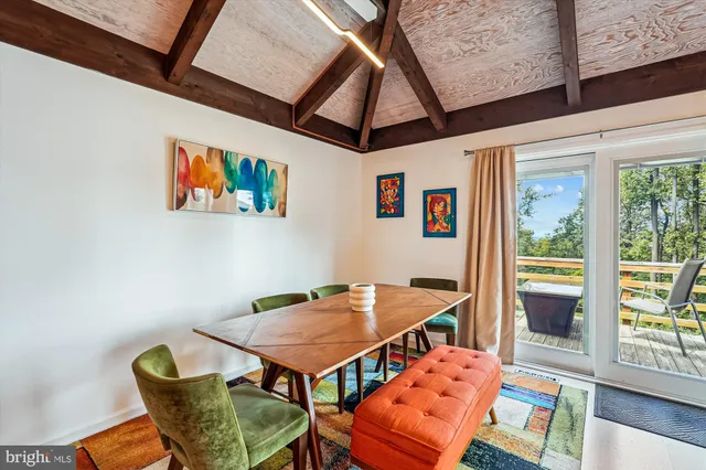 a view of swimming pool with lounge chair and dinning table under an umbrella
