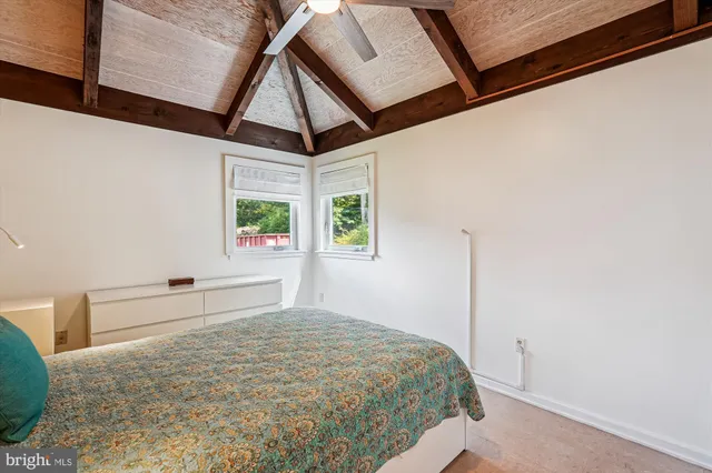 a bedroom with a large bed and a large window