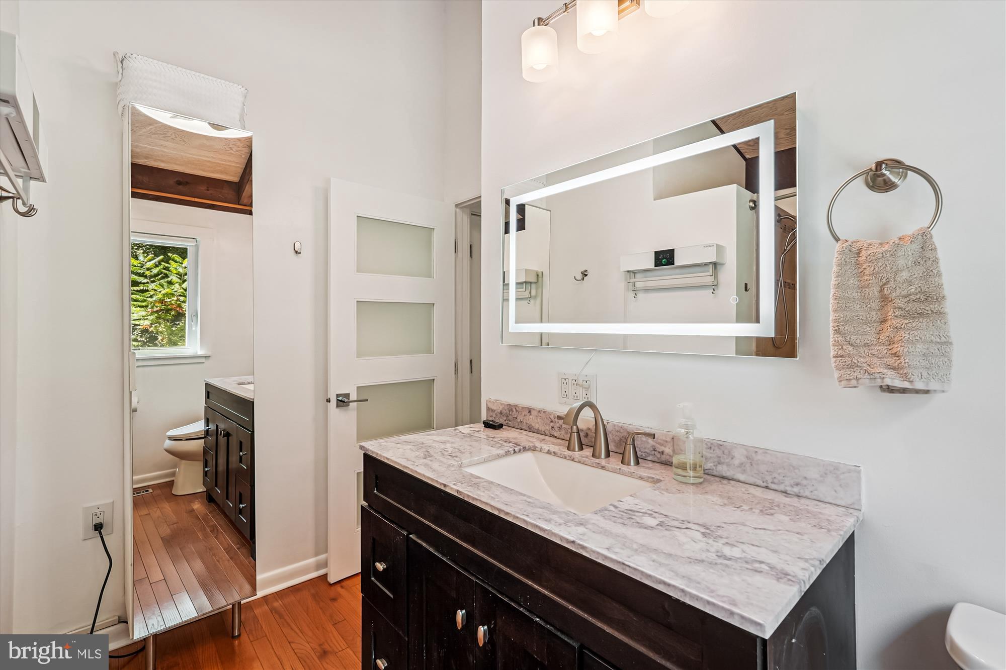 21826 Blue Ridge Mountain Road Paris, VA 20130 - Photo 41 of 60 a bathroom with a granite countertop sink a mirror and a toilet