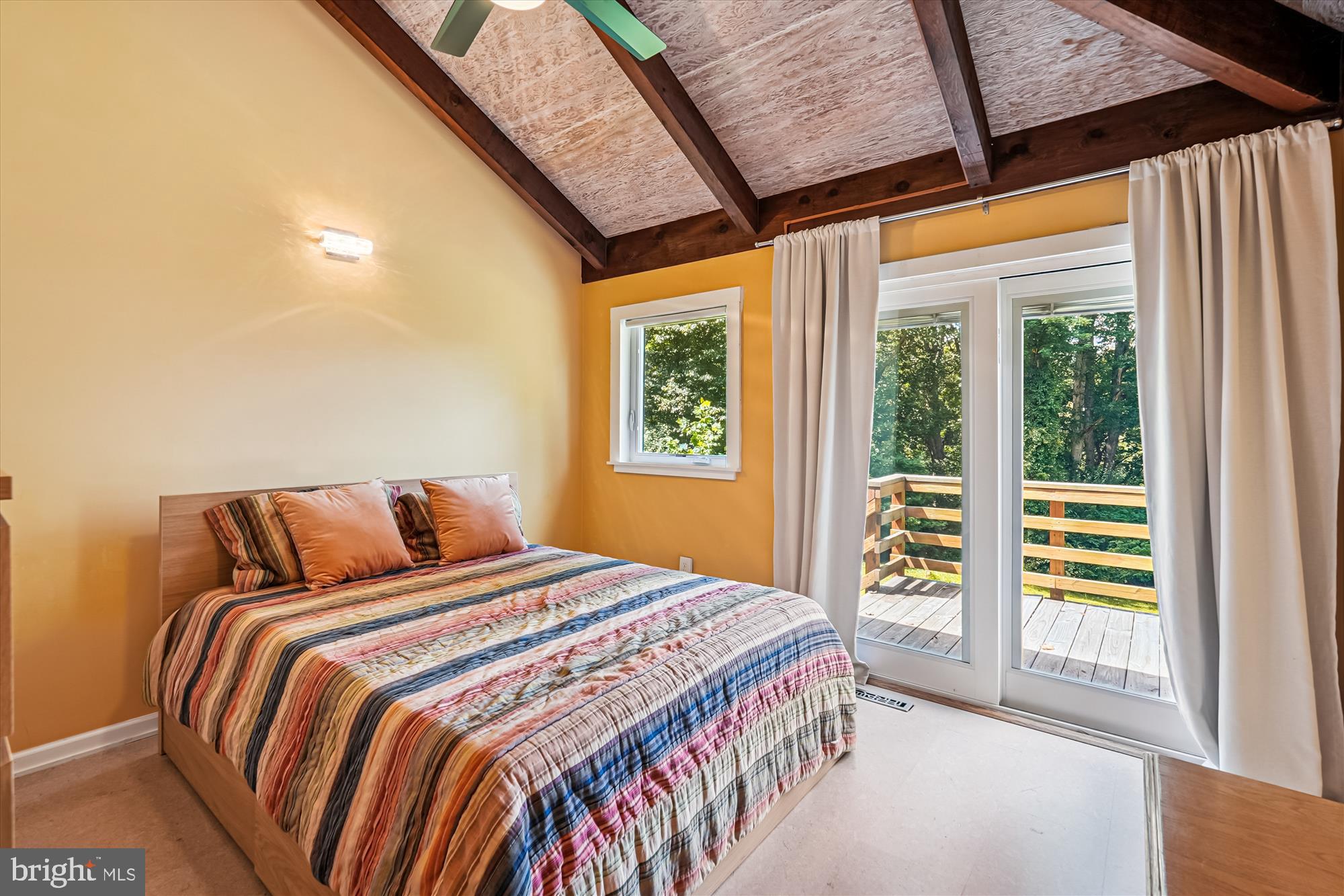 21826 Blue Ridge Mountain Road Paris, VA 20130 - Photo 42 of 60 a bedroom with a large bed and a large window