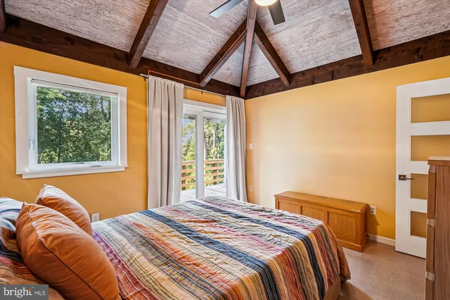 a view of house with backyard and wooden fence