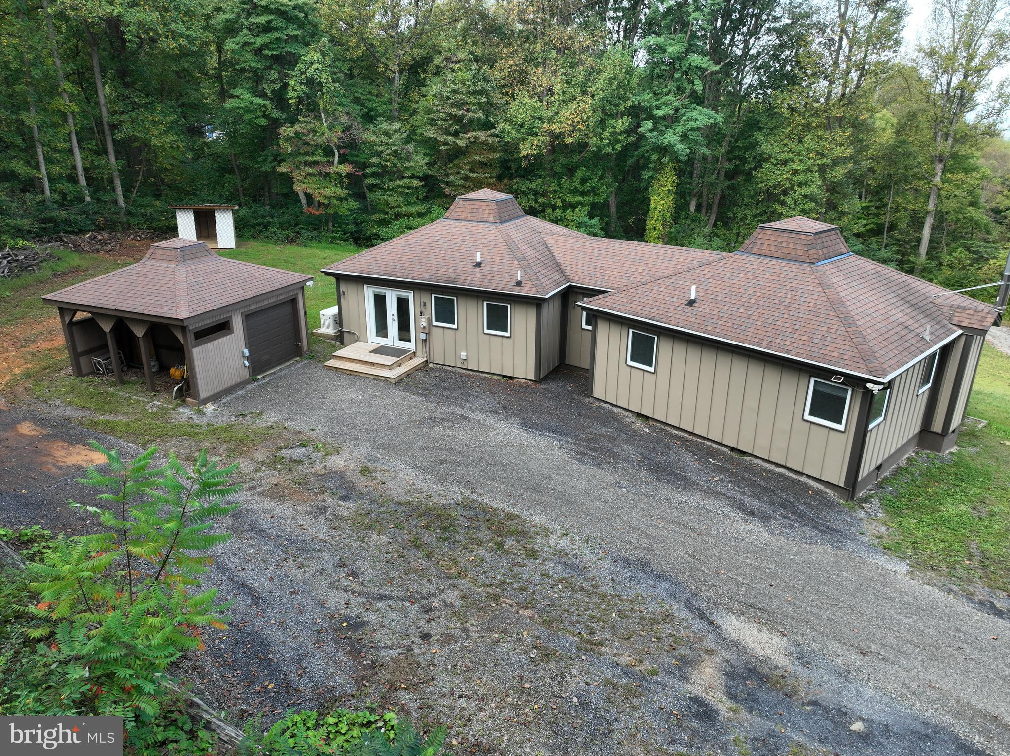 21826 Blue Ridge Mountain Road Paris, VA 20130 - Photo 6 of 60 a view of a house with a yard plants and large tree