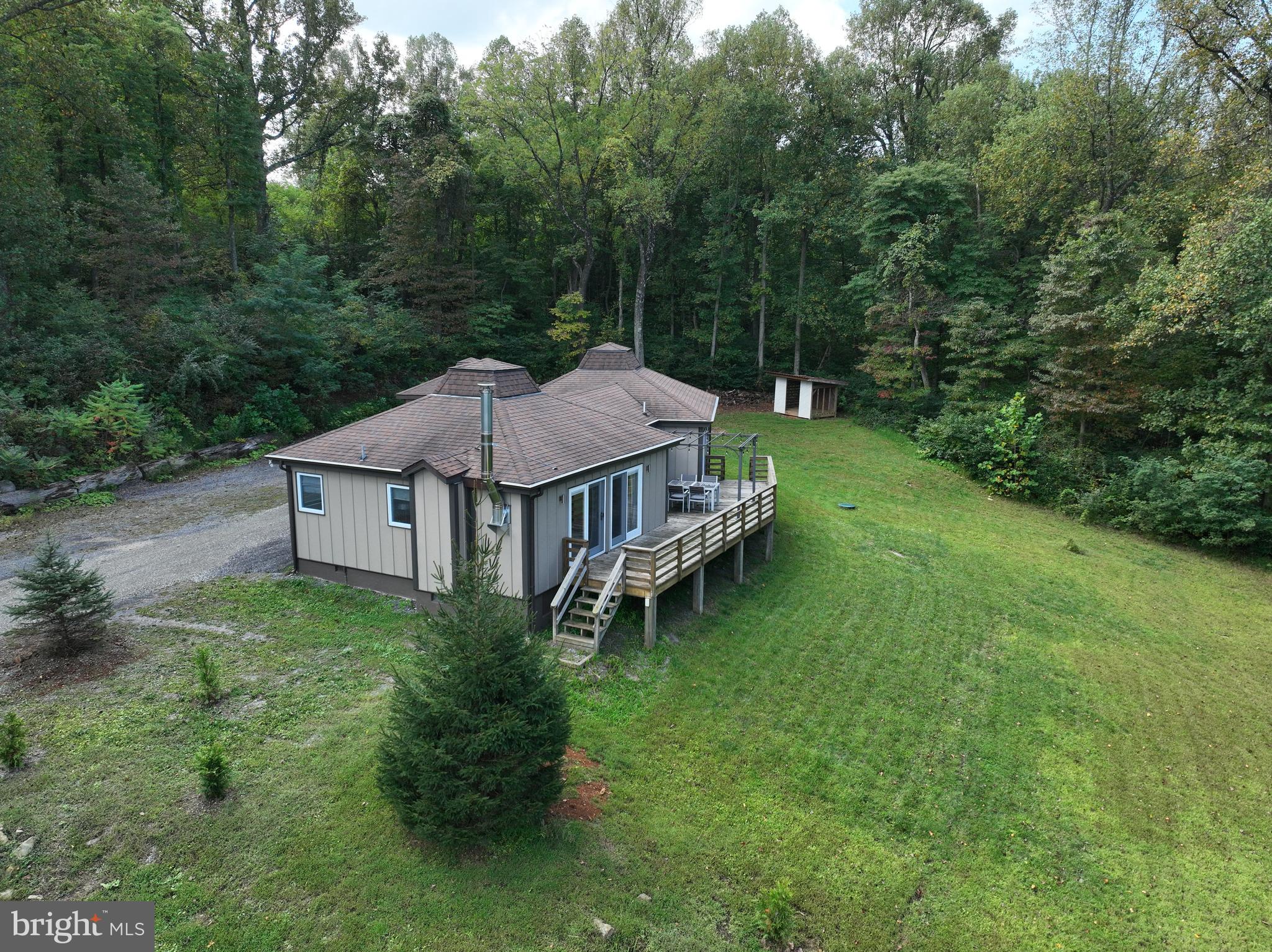 21826 Blue Ridge Mountain Road Paris, VA 20130 - Photo 10 of 60 a view of a house with a big yard and large trees