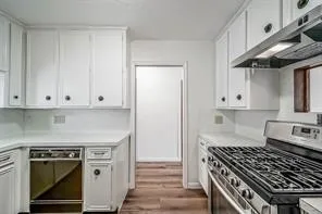 a kitchen with granite countertop a stove and a sink
