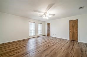 1111 Pecan Circle Seabrook, TX 77586 - Photo 16 of 31 a view of an empty room with window and wooden floor