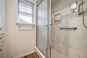a bathroom with a glass shower door