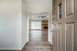 1111 Pecan Circle Seabrook, TX 77586 - Photo 4 of 31 a view of a hallway with wooden floor and staircase