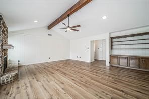 1111 Pecan Circle Seabrook, TX 77586 - Photo 5 of 31 a view of a livingroom with a ceiling fan and wooden floor