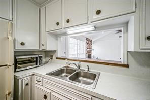 1111 Pecan Circle Seabrook, TX 77586 - Photo 10 of 31 a kitchen with a sink cabinets and a window