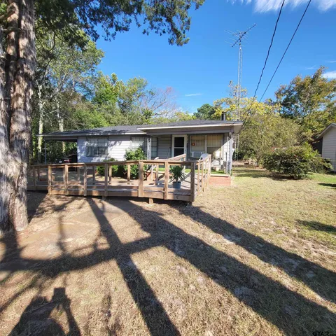 a view of a house with backyard porch and sitting area