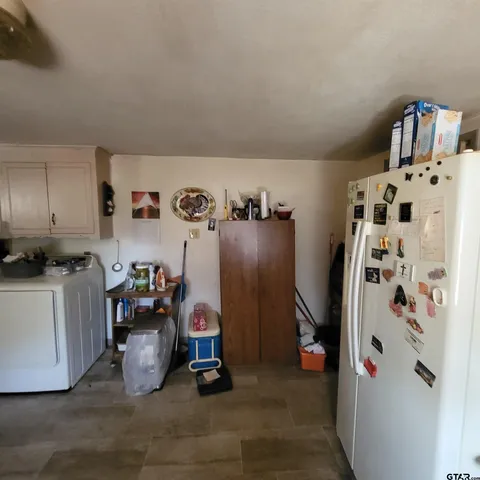 a view of a dining room with furniture and a potted plant