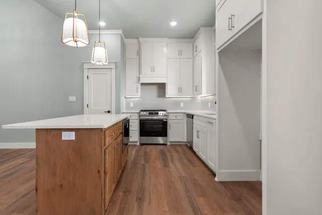 a kitchen with granite countertop a sink appliances a counter space and cabinets