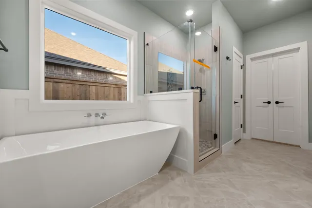 a bathroom with a bathtub and a shower