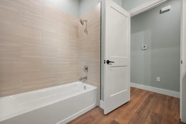 a bathroom with a bathtub and shower