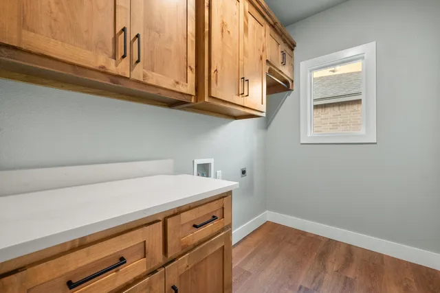 a kitchen with stainless steel appliances cabinets a stove and a window