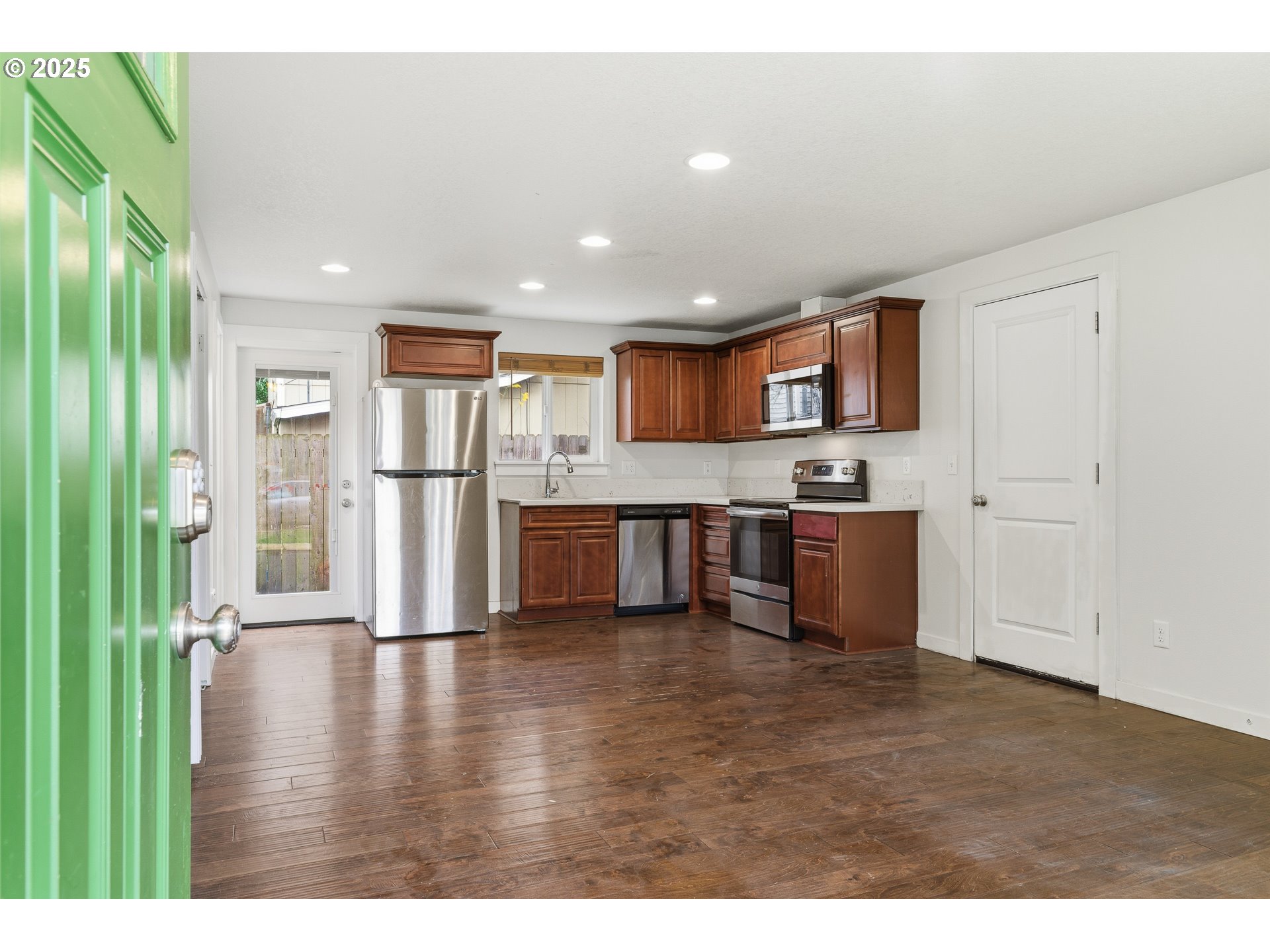 3223 Southeast 122nd Avenue Portland, OR 97236 - Photo 4 of 21 a kitchen with stainless steel appliances granite countertop a refrigerator a stove top oven a sink and dishwasher