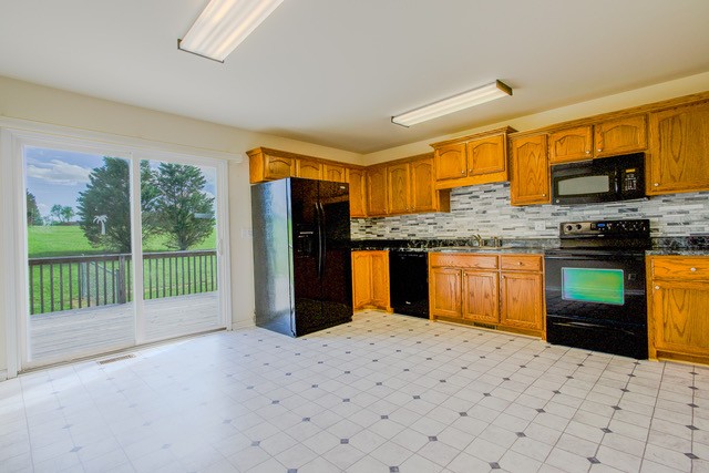 4272 J L Head Road Cedar Hill, TN 37032 - Photo 14 of 30 a kitchen with stainless steel appliances kitchen island granite countertop a refrigerator and stove top oven