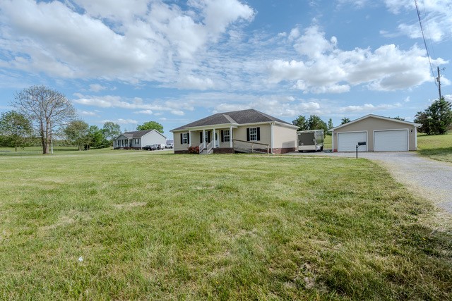 4272 J L Head Road Cedar Hill, TN 37032 - Photo 30 of 30 a view of a house with a big yard and large trees
