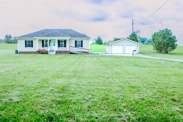 4272 J L Head Road Cedar Hill, TN 37032 - Photo 3 of 30 a front view of a house with a garden