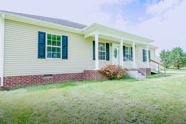 4272 J L Head Road Cedar Hill, TN 37032 - Photo 4 of 30 a front view of a house with a garden