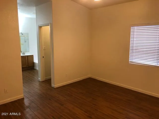 a view of a room with wooden floor and a sink