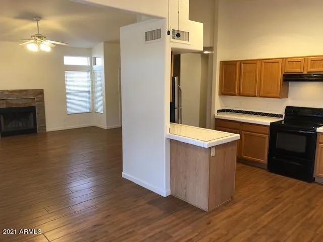 a kitchen with kitchen island cabinets and wooden floor